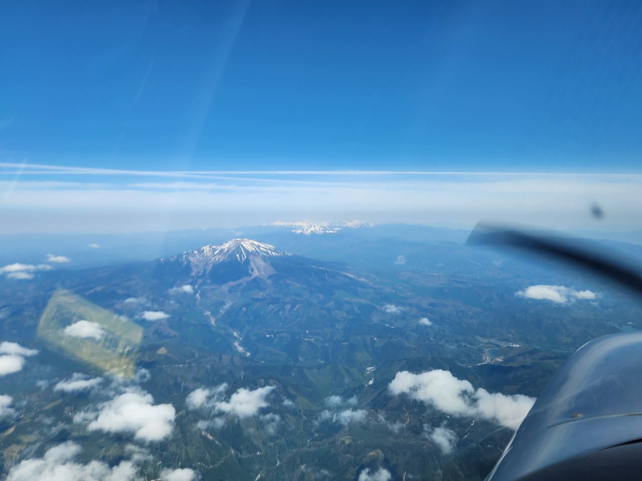 飛行中の機内から見た山並みと青空